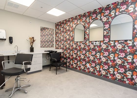 Beauty salon with floral wallpaper and mirrors