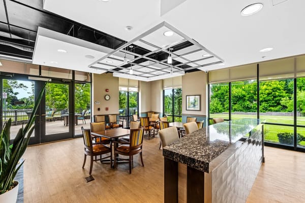 Bright common area with seating and large windows