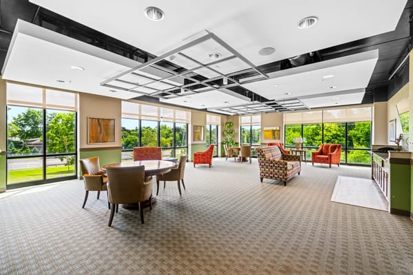 Bright common area with seating and large windows