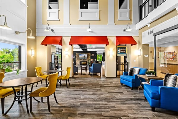 Bright common area with seating and bookshelves