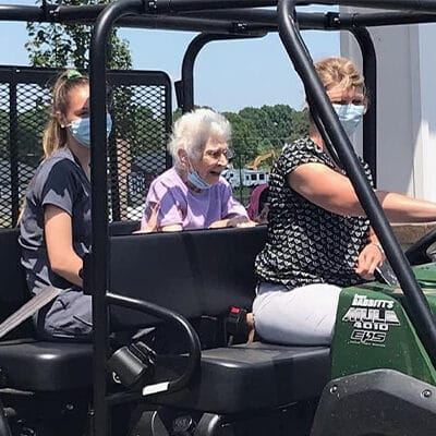 Residents and staff in a vehicle at the facility