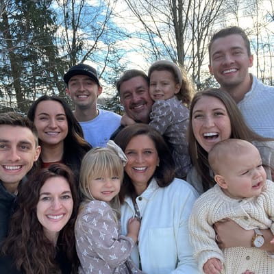 Group of people smiling outdoors in a casual setting