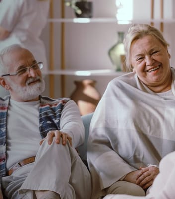 Two smiling residents enjoying time together in a common area