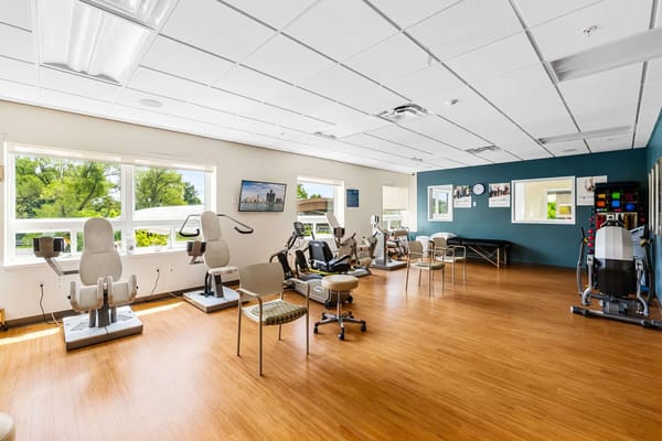 Physical therapy room with exercise equipment and natural light