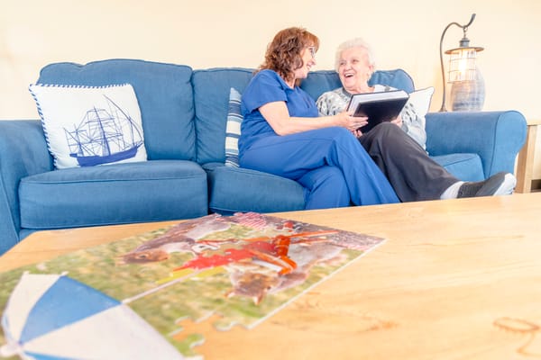 Staff member engaging with a resident while completing a puzzle