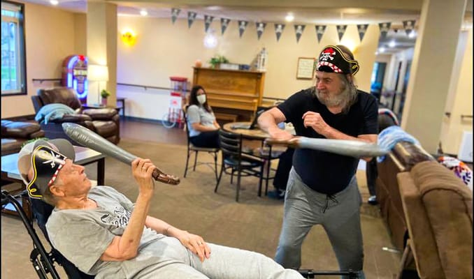 Residents engaging in a playful swordfight activity