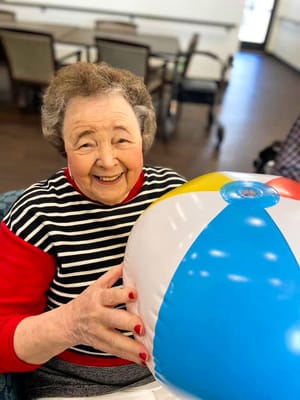 Resident enjoying activities with a beach ball