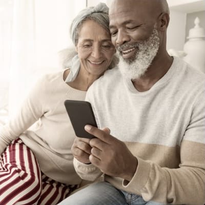 Couple enjoying a moment together, looking at a smartphone
