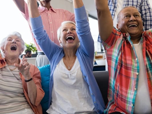 Residents joyfully celebrating together in a common area