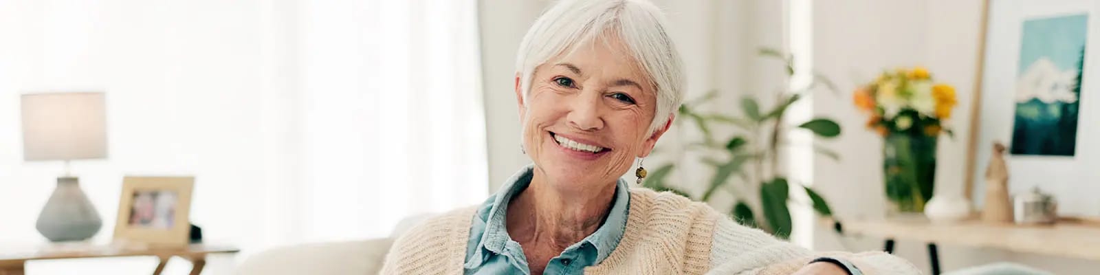 A smiling senior woman in a cozy living room