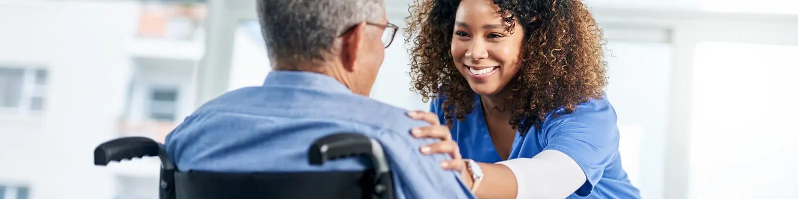 Staff member interacting with a resident in a caregiving setting