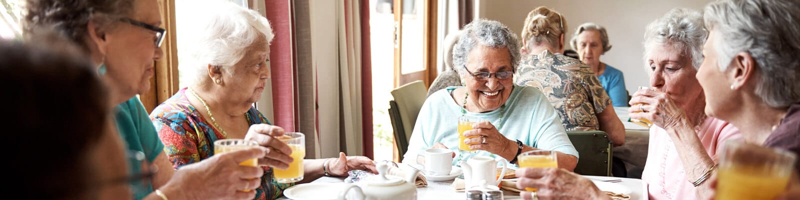 Residents enjoying drinks in the dining room