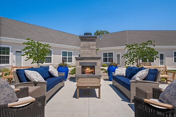 Cozy outdoor seating area with fire pit and greenery