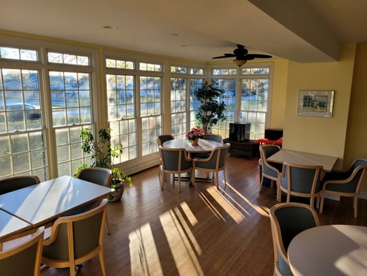Bright common area with large windows and seating