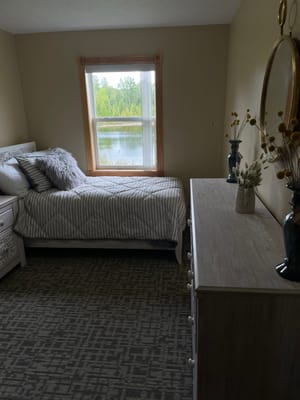 Cozy bedroom with a view facing a lake