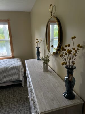 Cozy resident room with decorative vases and a mirror
