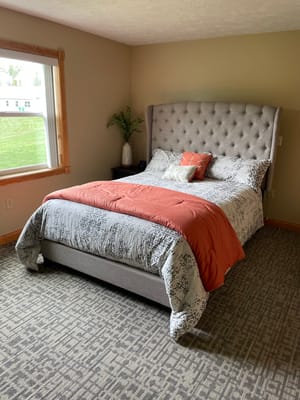 Cozy resident bedroom with a large bed and window