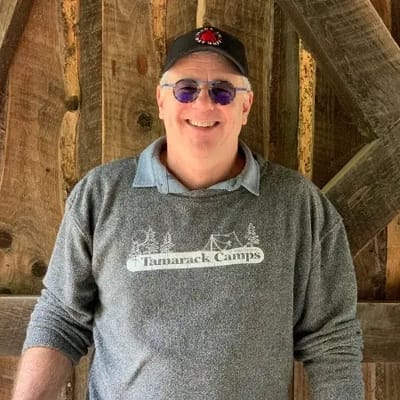 Smiling man wearing Tamarack Camps apparel