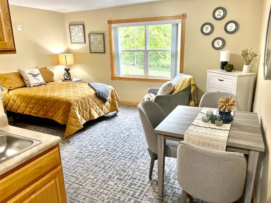 Cozy interior of a resident room with a bed and seating area
