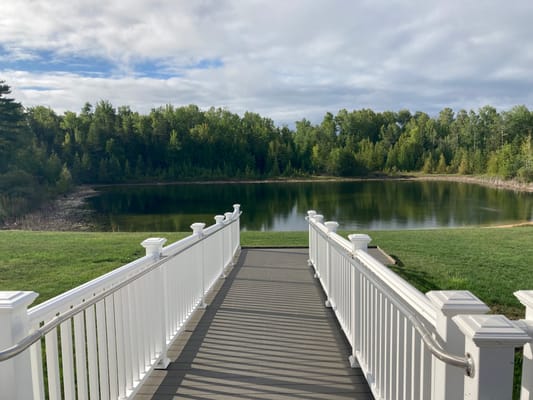 Pathway leading to a serene pond surrounded by trees