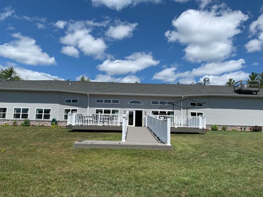 Exterior view of a senior living facility with a ramp