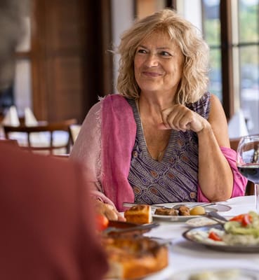 Resident enjoying a meal in the dining area