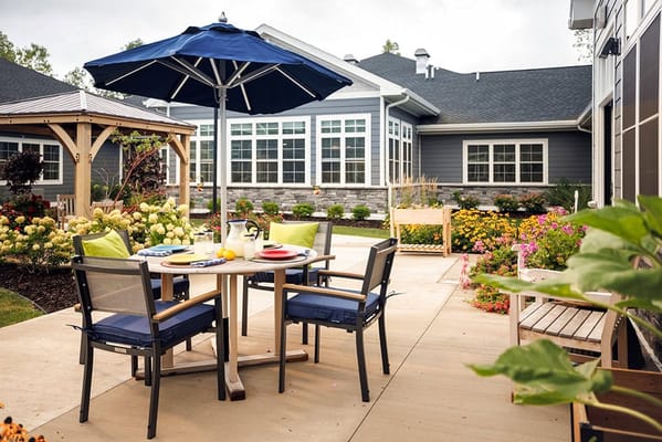 Outdoor courtyard with seating area and flowers