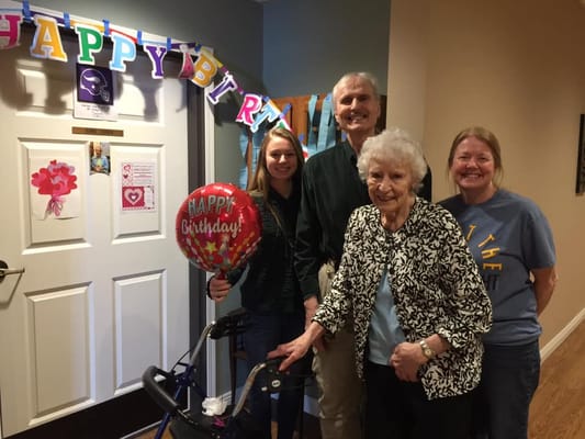 Residents celebrating a birthday with family and staff