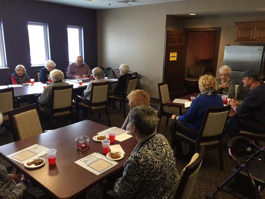 Residents socializing in a common area activity room