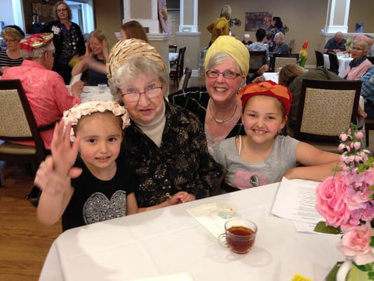 Residents and children sharing a joyful moment at a table