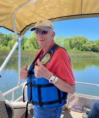 Resident enjoying a boat ride with thumbs up