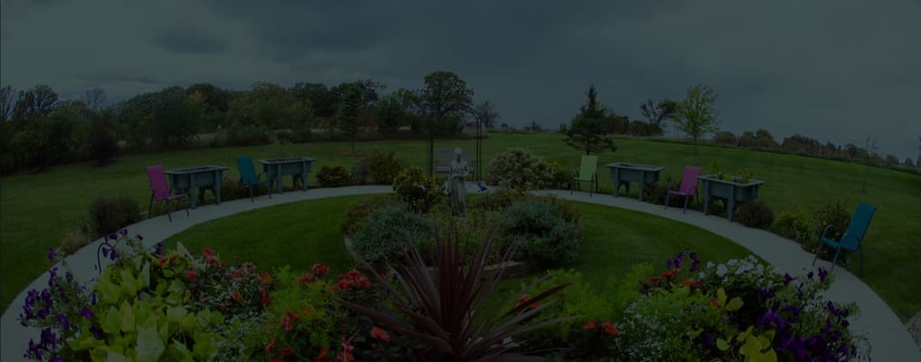 Well-maintained garden area with colorful chairs and plants