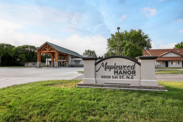 Exterior view of Maplewood Manor entrance and signage