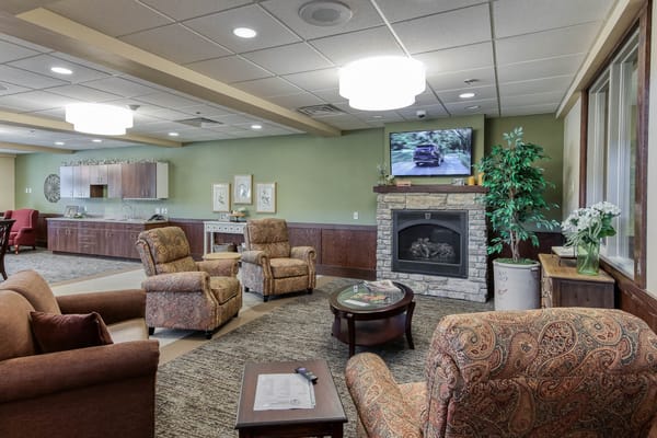 A cozy common area with comfortable seating and a TV