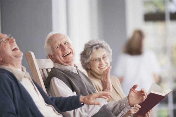 Seniors enjoying conversation in a comfortable lounge
