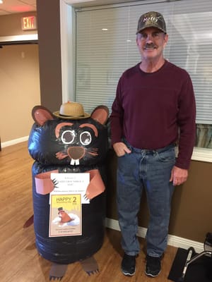 Resident posing with a playful decoration in a common area