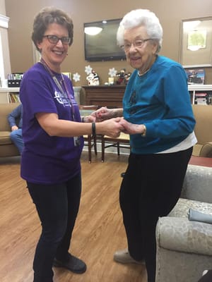 Staff member dancing with a resident in a common area