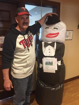 Resident posing with a fun decoration in the facility