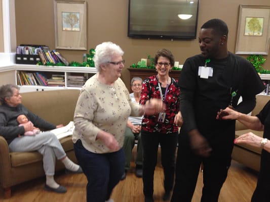 Residents and staff engaged in an activity in the common area