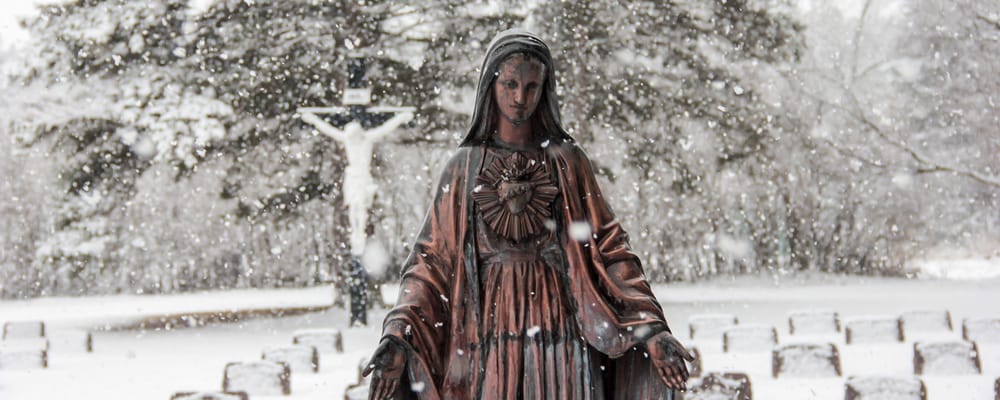 Statue surrounded by snow in a serene outdoor space