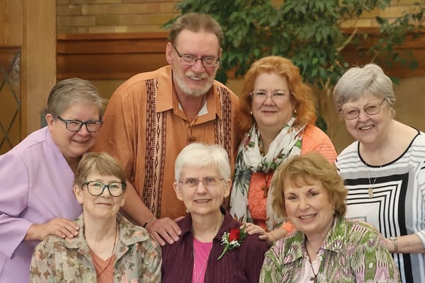 Group of residents and staff smiling together indoors