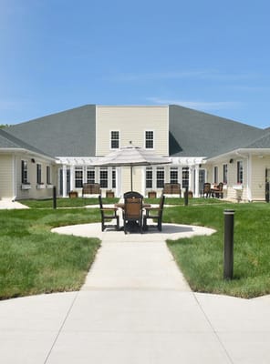 Outdoor patio area with seating and grass
