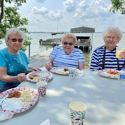 Residents enjoying a meal outdoors by the water