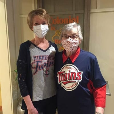 Staff and resident wearing Minnesota Twins shirts inside a facility
