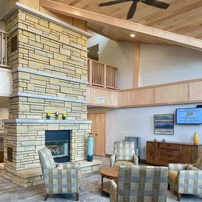 Bright common area with seating and fireplace