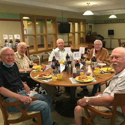 Residents enjoying a meal together at a round table