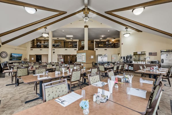 Bright dining room with tables set for residents