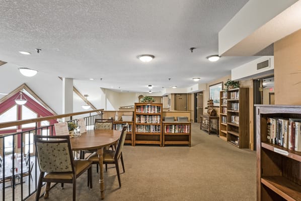 Interior view of a cozy library area with bookshelves and seating