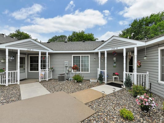 Outdoor view of cottages with flower beds and paths