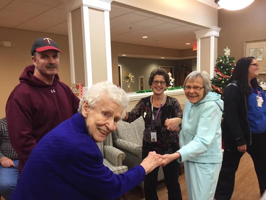 Residents participating in a joyful group activity in the common area